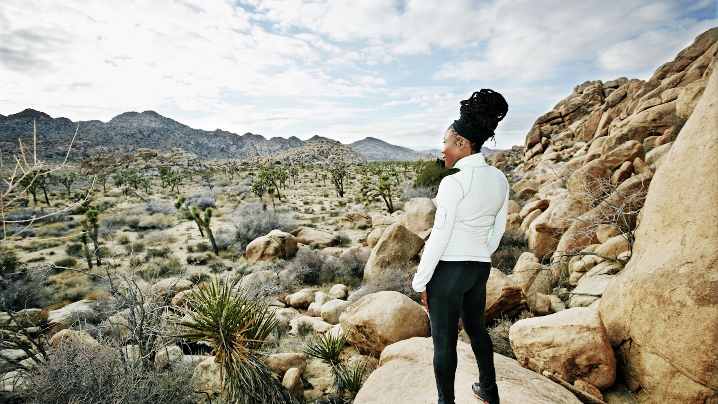 Black runner in desert landscape, Joshua Tree National Park, California, United States - stock photo