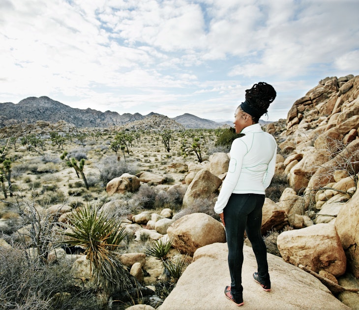 Black runner in desert landscape, Joshua Tree National Park, California, United States - stock photo