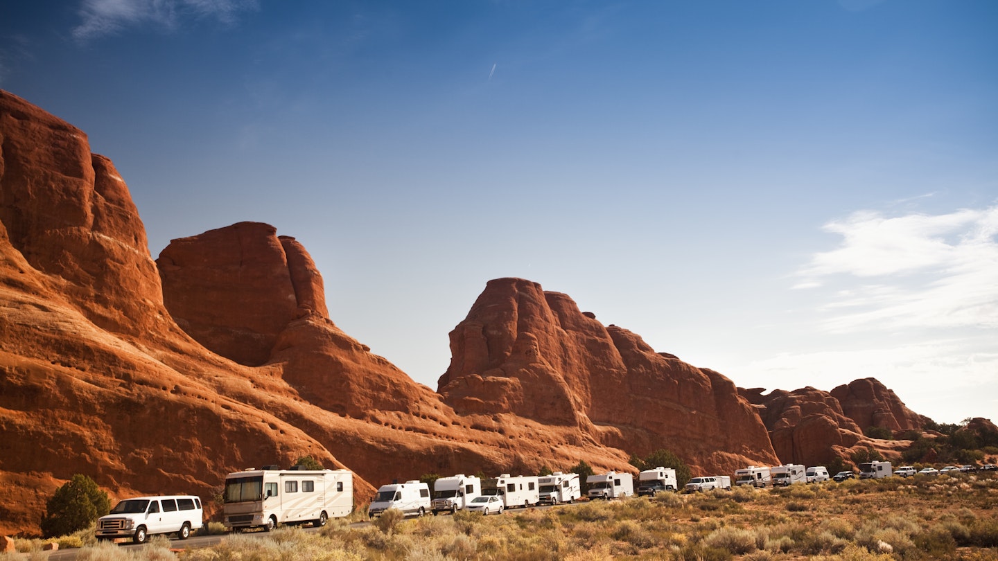 Crowded motor home campers on vacation in the southwest USA red rock landscape in Arches National Park near Moab Utah