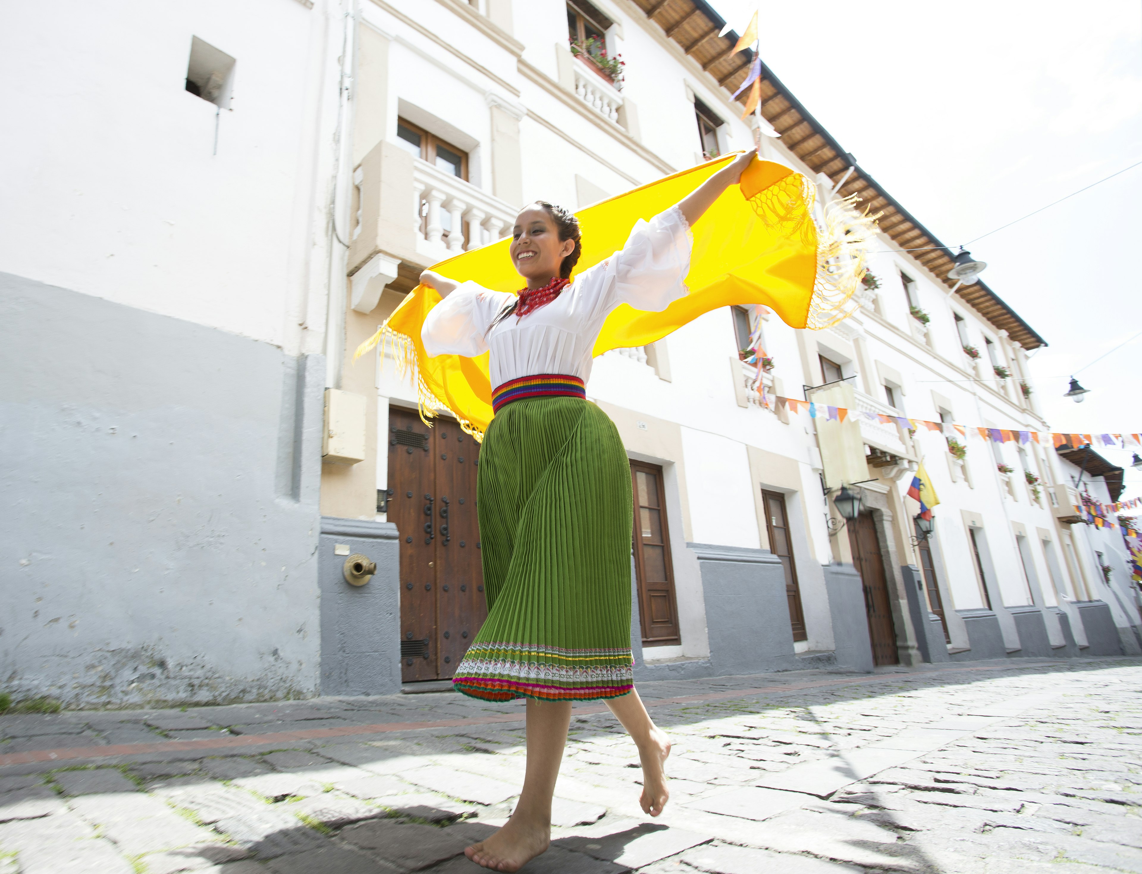 A female dancer with a yellow scarf on the street in Quito, Ecuador