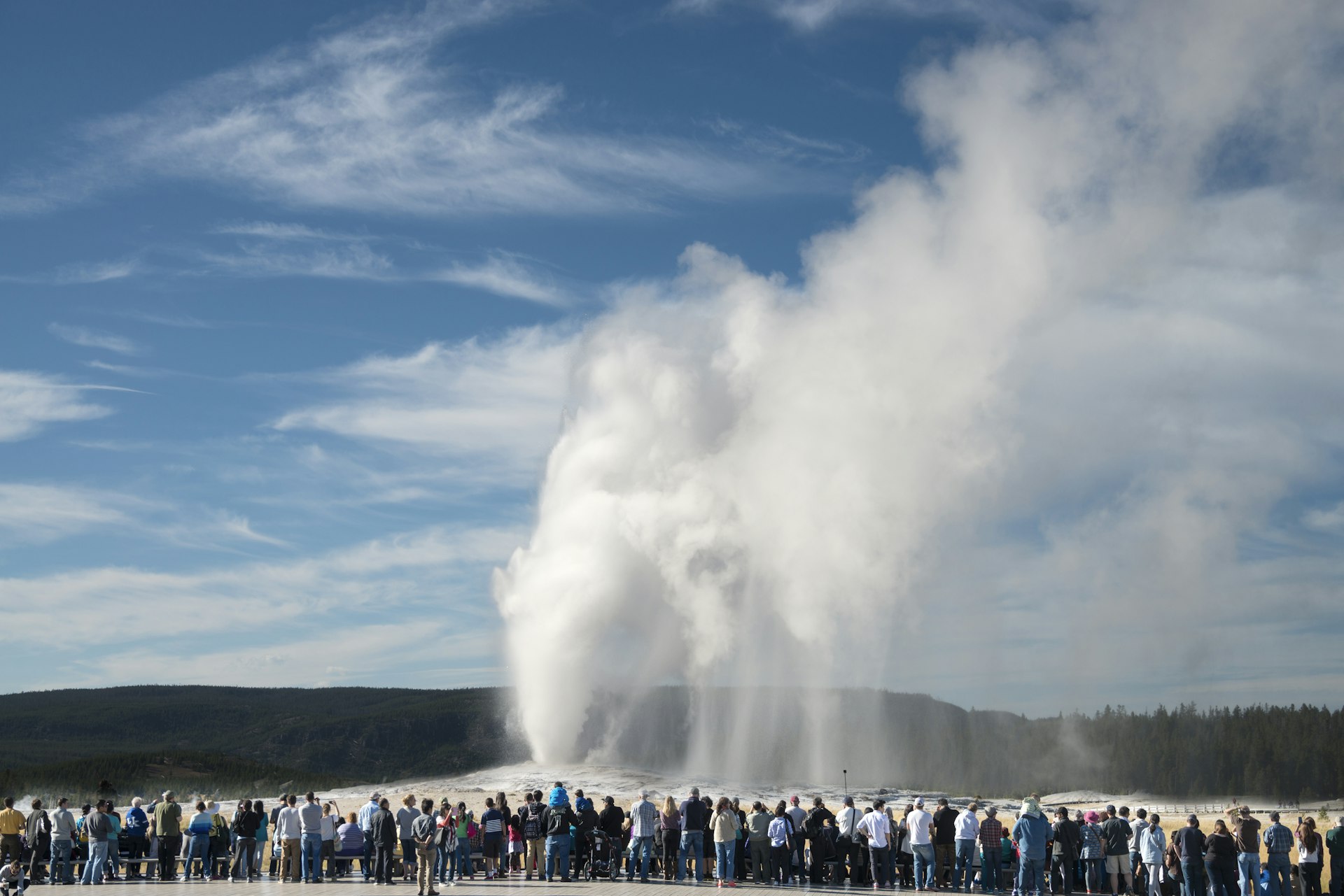 A crowd watching Old Faithful in Yellowstone National Park