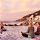 people having a yoga session on the beach