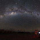 Astronomer with a telescope looking at the Milky Way in the Atacama Desert, Chile.