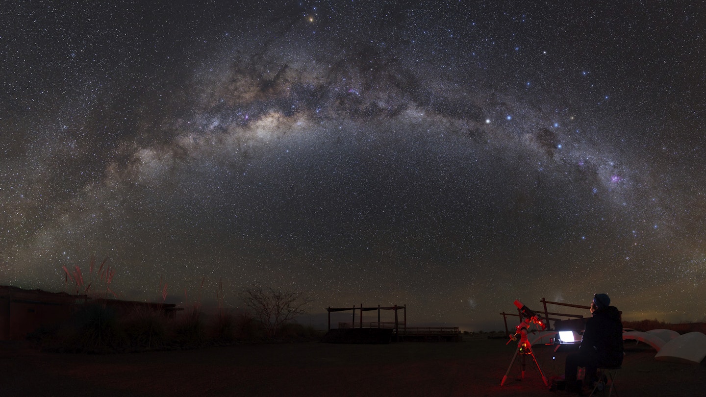 Astronomer with a telescope looking at the Milky Way in the Atacama Desert, Chile.