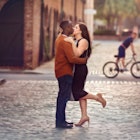 Couple kissing on a Charleston street in fall