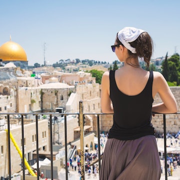 Girl looks at the Wailing Wall in Jerusalem