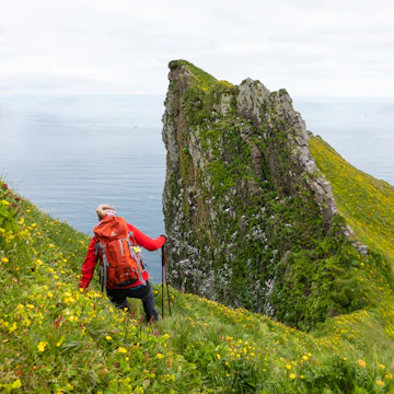 A woman hikes in Hornstrandir Nature Reserve.