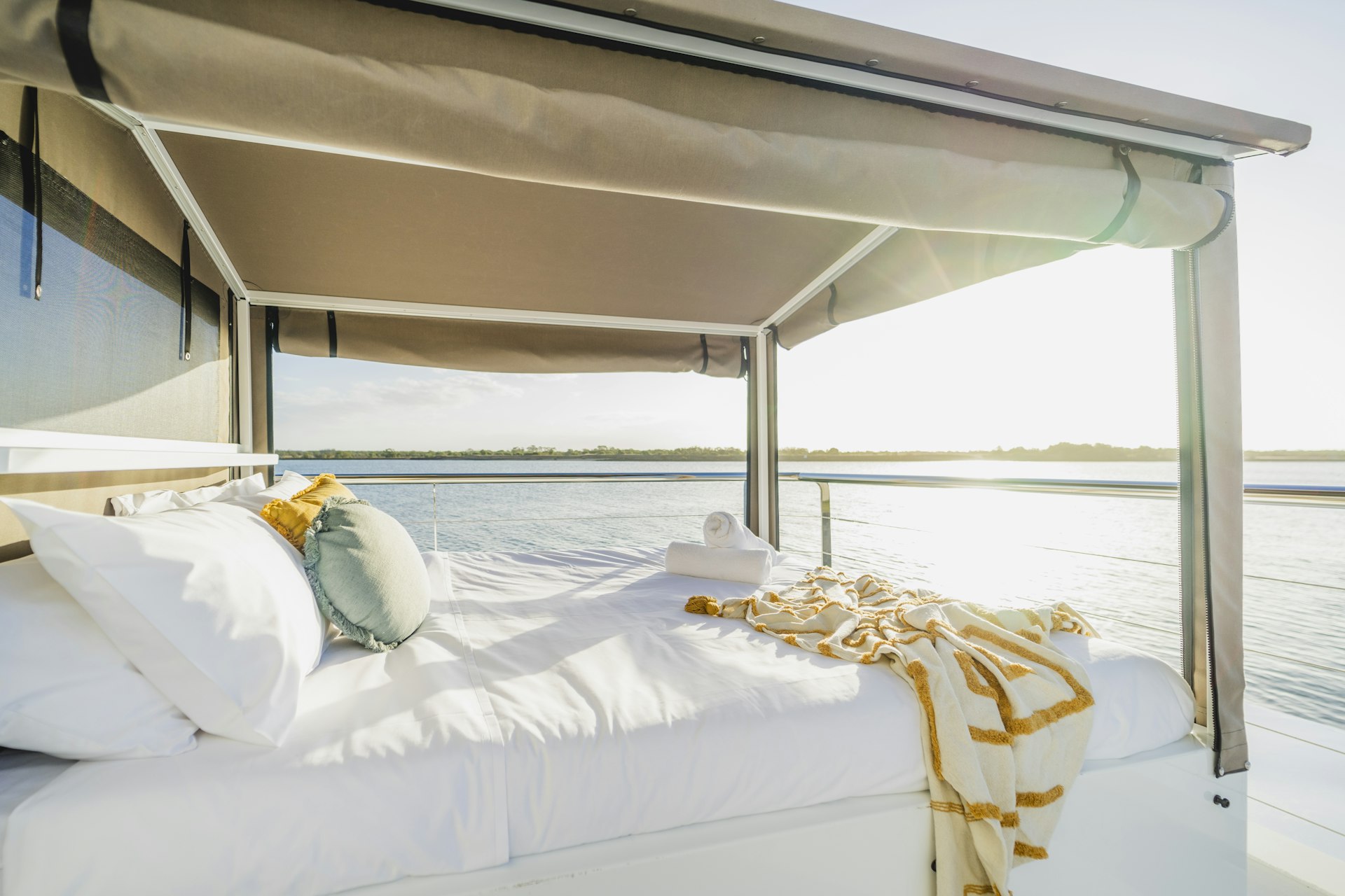 An upper-deck, queen bed on the Lady Musgrave Experience pontoon