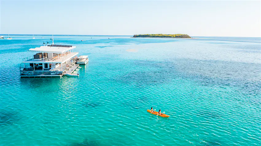 Kayakers explore the southern edge of the Great Barrier Reef, deploying from the Lady Musgrave Experience pontoon boat Kayakers explore the southern edge of the Great Barrier Reef, deploying from the Lady Musgrave Experience pontoon boat