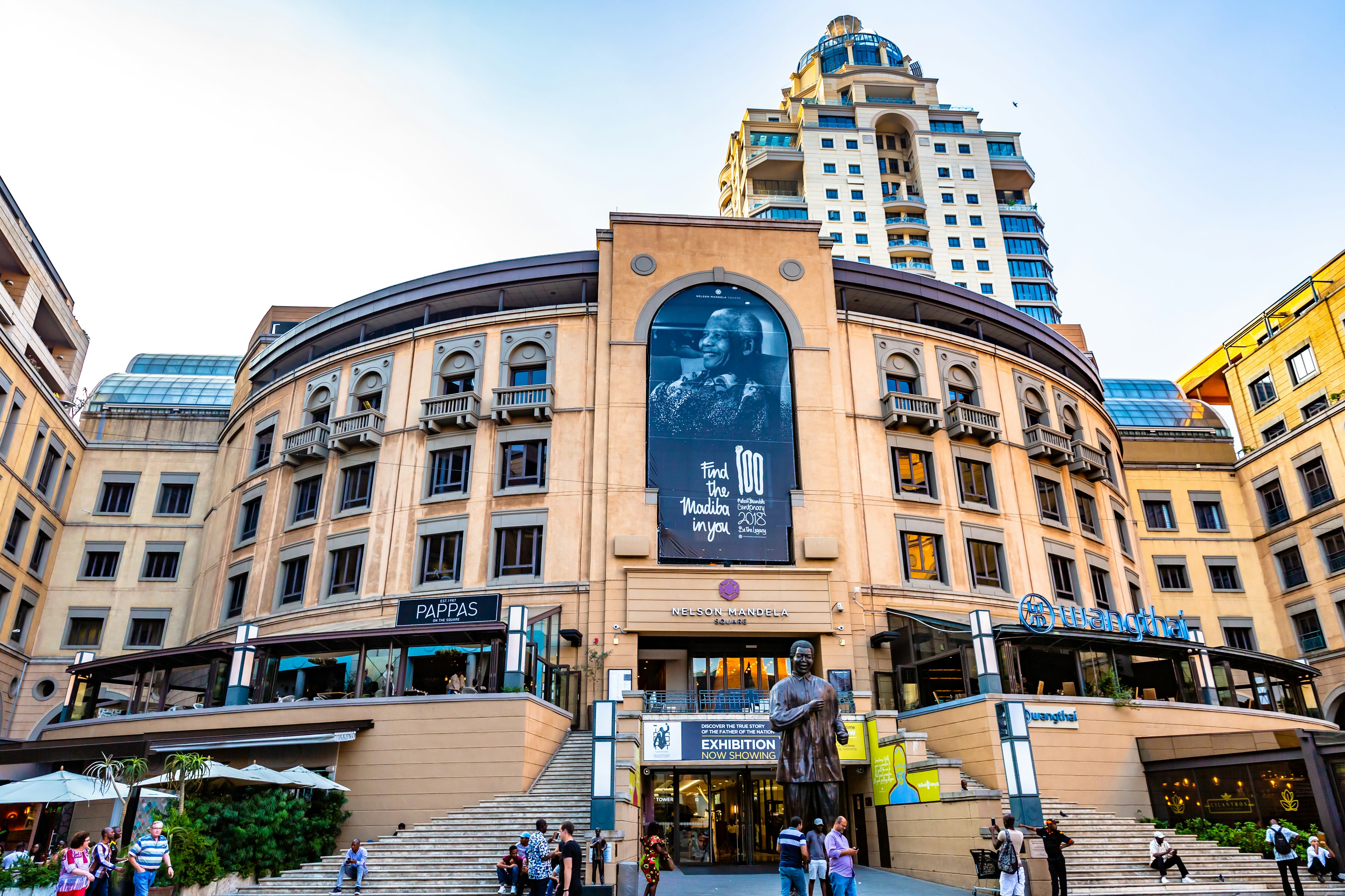 This image shows the famous Nelson Mandela Square is a public space and shopping area. It has big statue of Nelson Mandela and water fountain. The pic is taken in march 2019 in Johannesburg, South Africa.