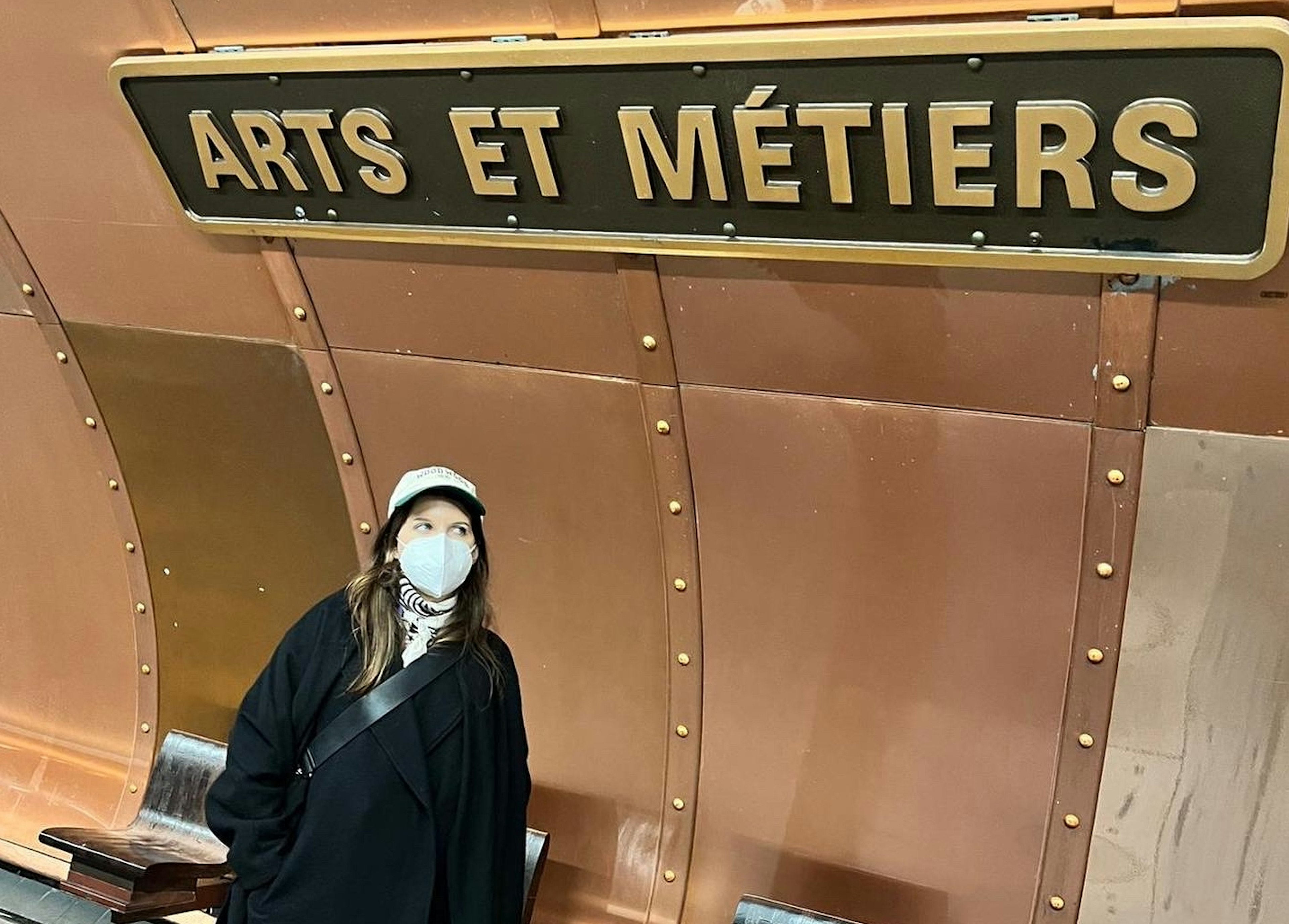 Woman wearing mask at a Paris metro station stop