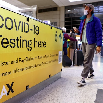 LOS ANGELES, CALIFORNIA - DECEMBER 01: A COVID-19 test center operates inside the Tom Bradley International Terminal at Los Angeles International Airport (LAX) on December 01, 2021 in Los Angeles, California. The Biden administration is planning to announce tighter restrictions for travelers flying into the United States, including requiring a negative test for COVID-19 one day ahead of travel, in response to the new Omicron variant. (Photo by Mario Tama/Getty Images)