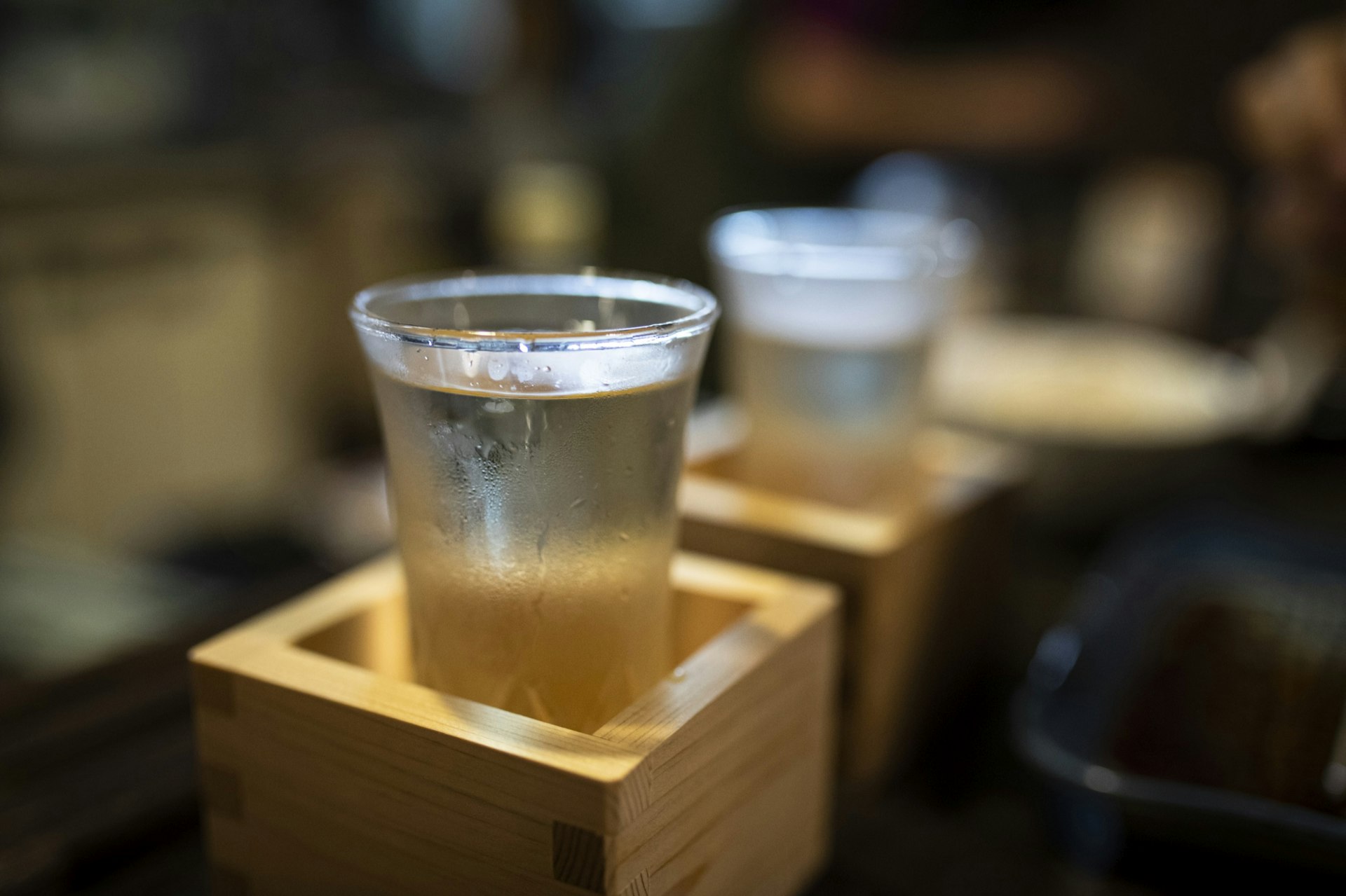 Japan, Takayama, Sake served in masu in traditional Japanese restaurant