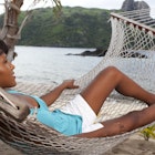 Attractive woman relaxing in a hammock in Fiji