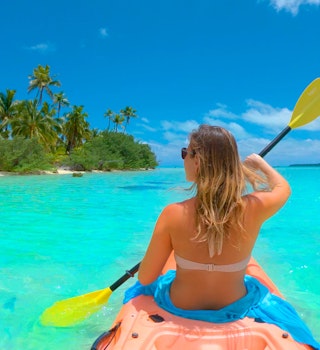 Woman kayaking in Cook Islands.