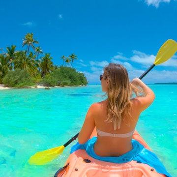 Woman kayaking in Cook Islands.