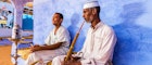 "Two Muslim men smoking sheesha (waterpipe) in Nubian Village near Aswan, Southern Egypt, Africa."