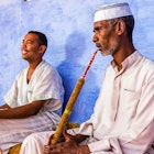 "Two Muslim men smoking sheesha (waterpipe) in Nubian Village near Aswan, Southern Egypt, Africa."