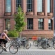 Student riding bike past Freiburg University.