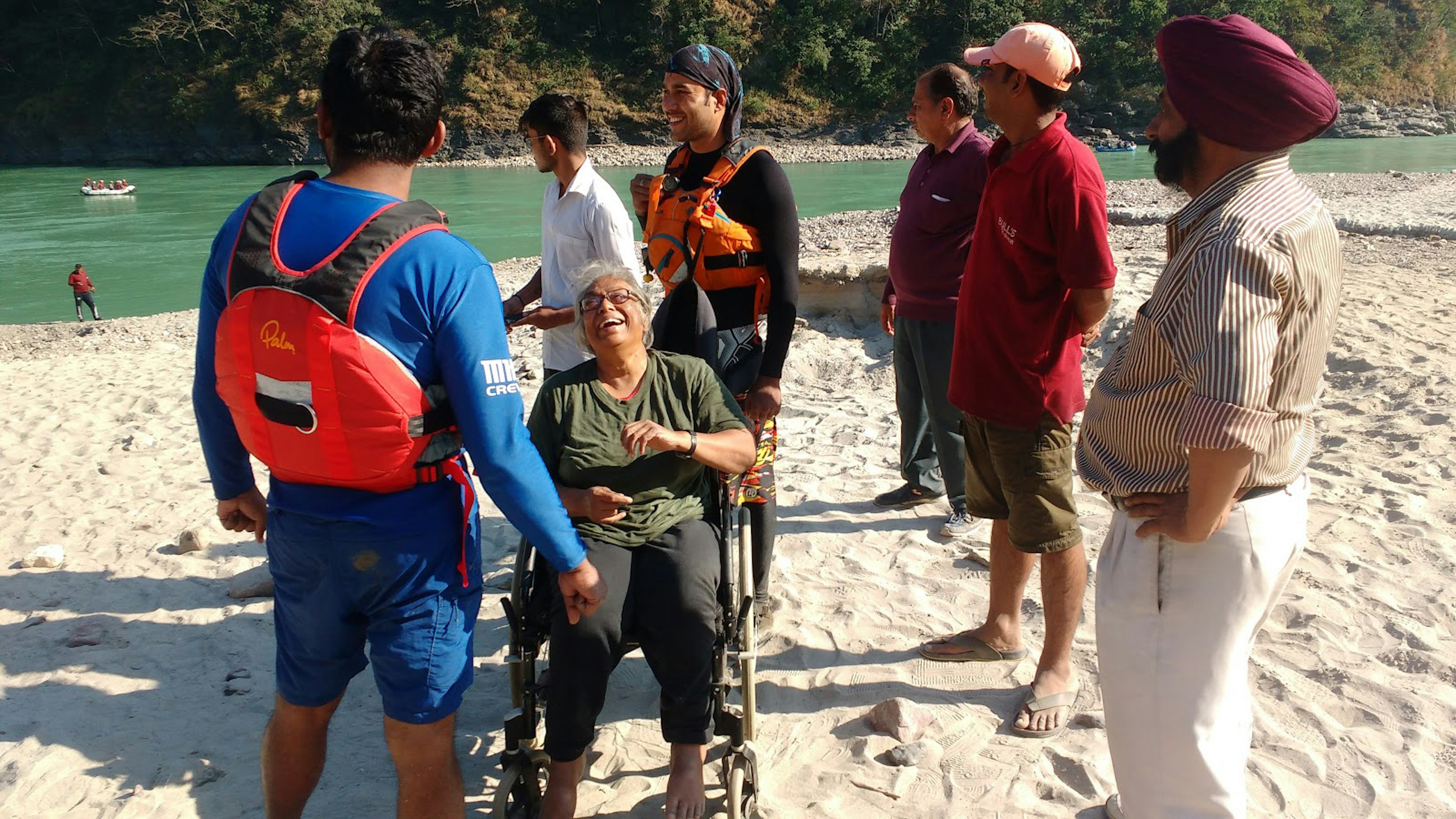 A group of travelers gathered on a riverbank.