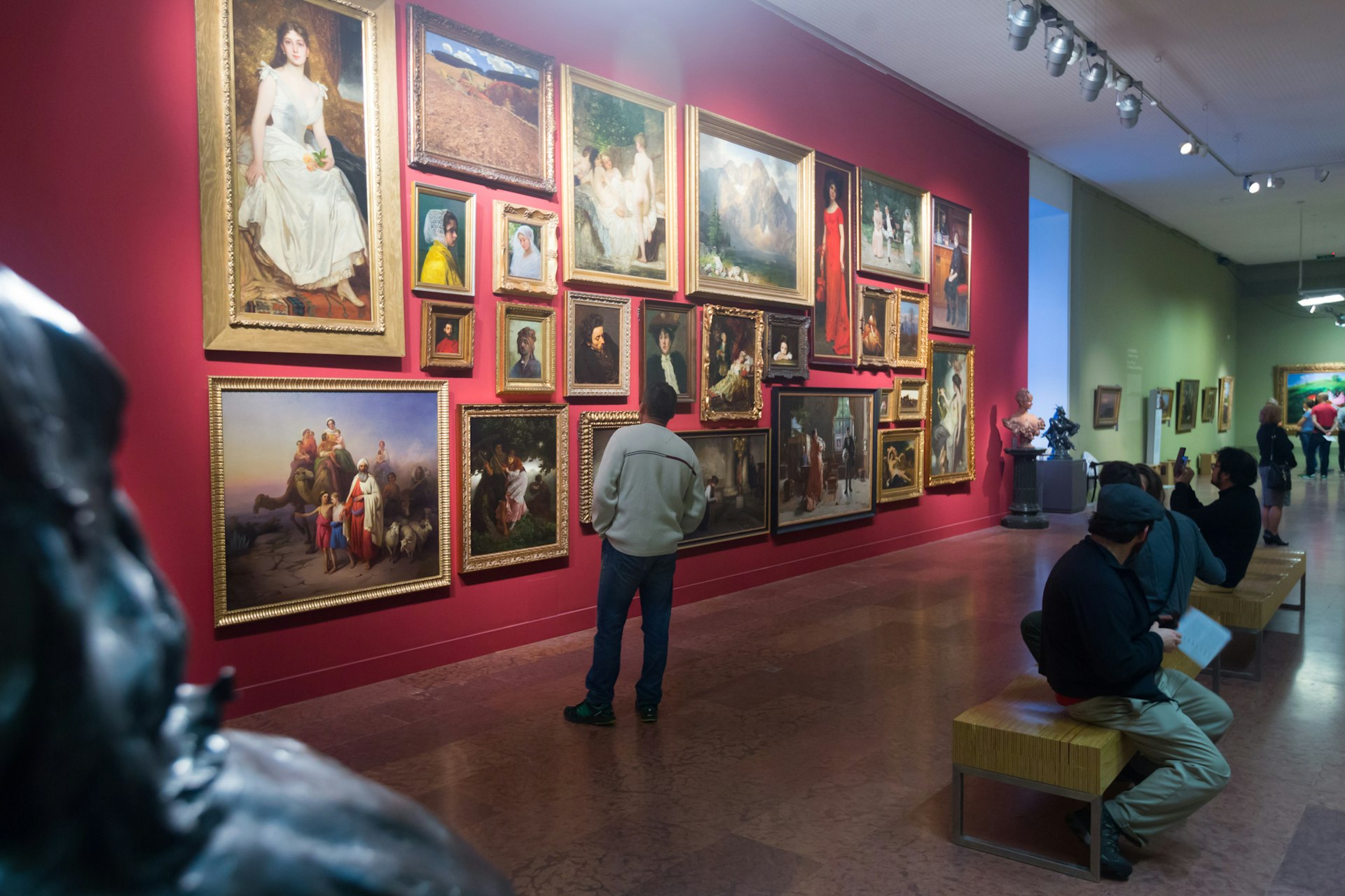 Visitors look at paintings on walls at the Hungarian National Gallery in Buda Castle, Budapest