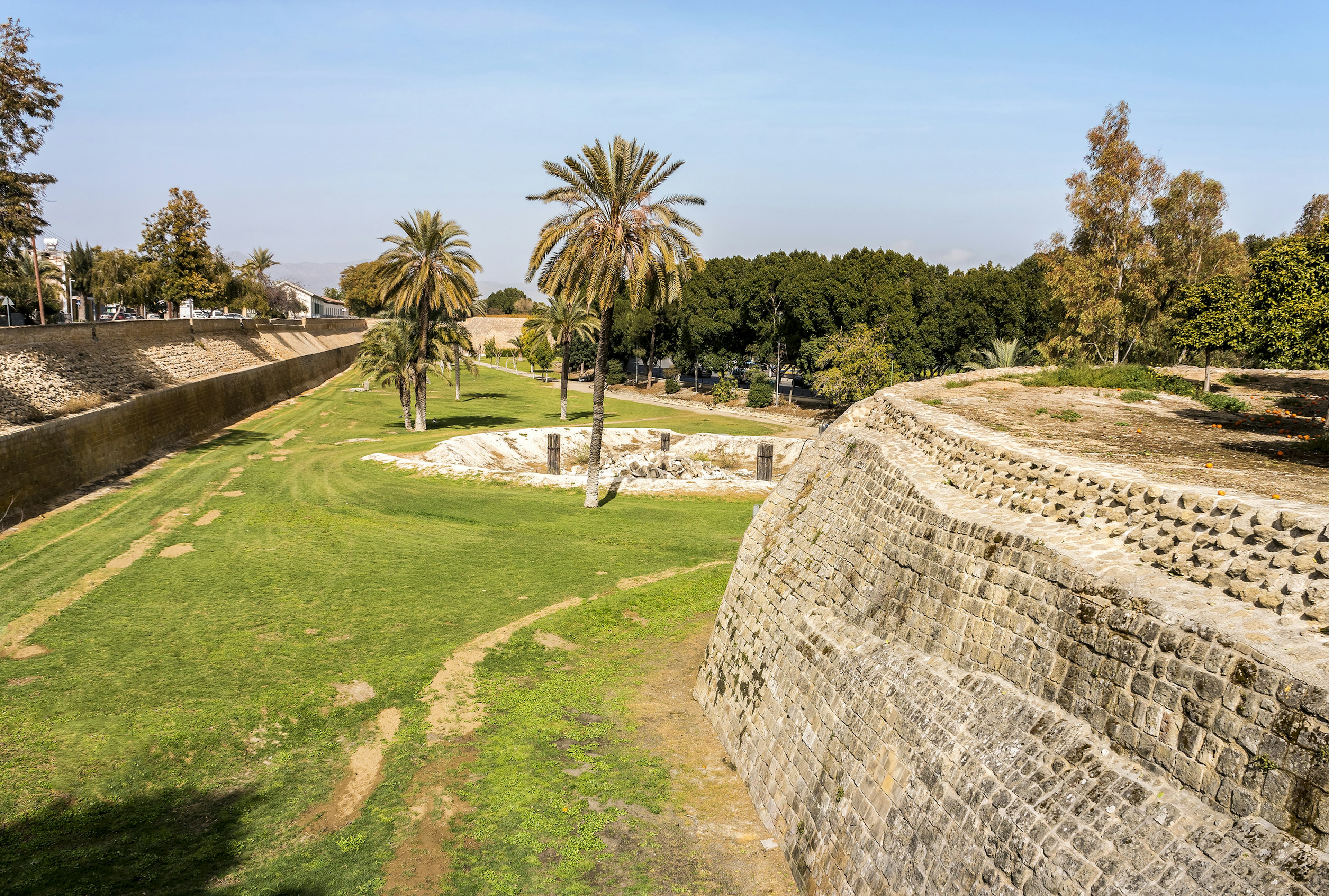 The 16th century Venetian walls of Nicosia, Cyprus, on the right and green grass on the left