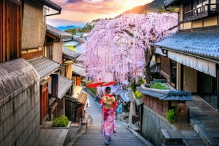 Woman wearing a traditional Japanese kimono in the Historic Higashiyama district during spring.
