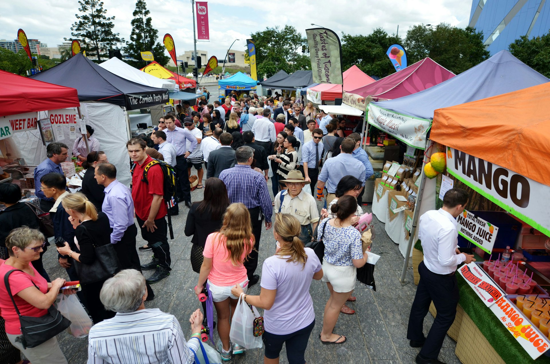 People shopping at Jan Powers Farmers Market in Brisbane City.It provide the best produce in Queensland of fresh fruits, vegetables and food to Brisbane, Australia.