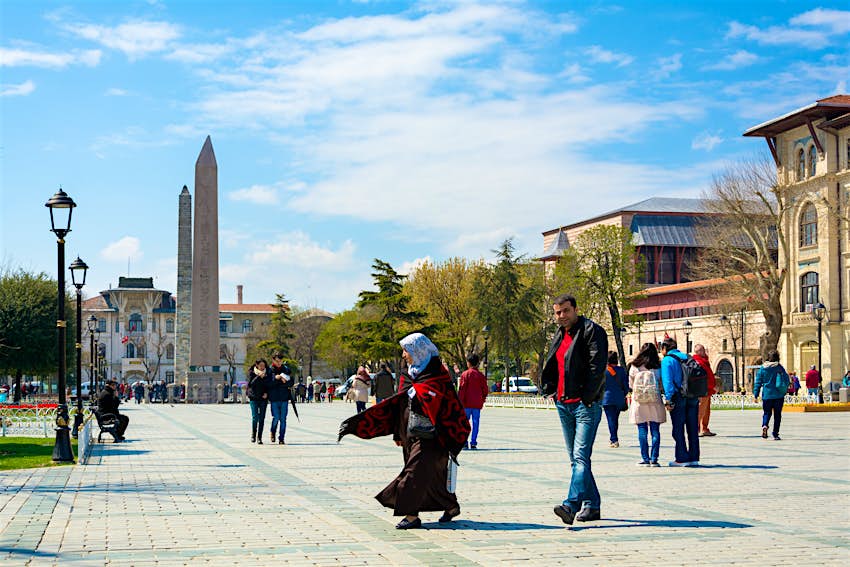 People walking in Sultan Ahmet Square near the Obelisk of Theodosius People walking in Sultan Ahmet Square near the Obelisk of Theodosius