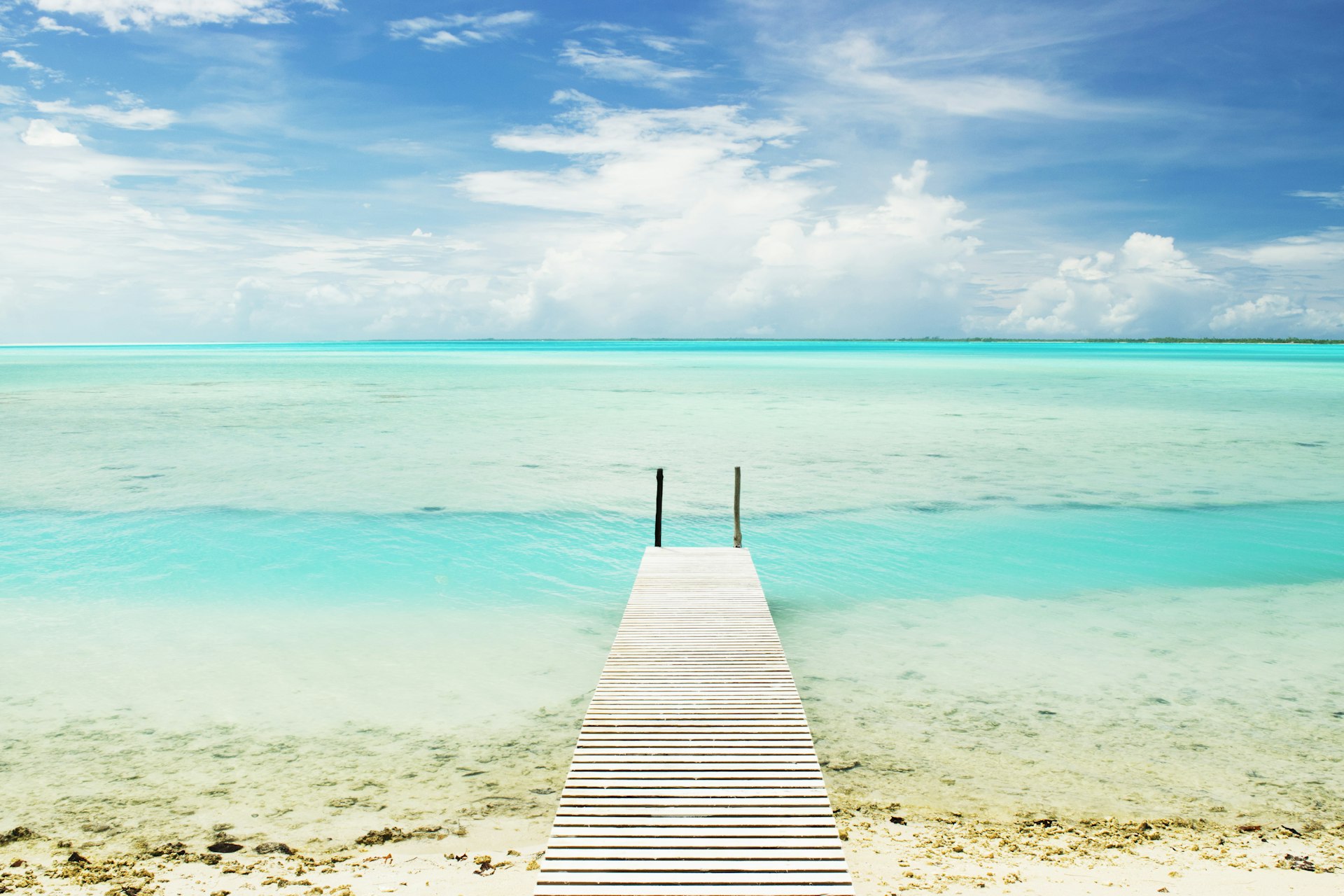 A small boardwalk jetting out over the lagoon in atoll Anaa, which is part of the Tuamotus in French Polynesia