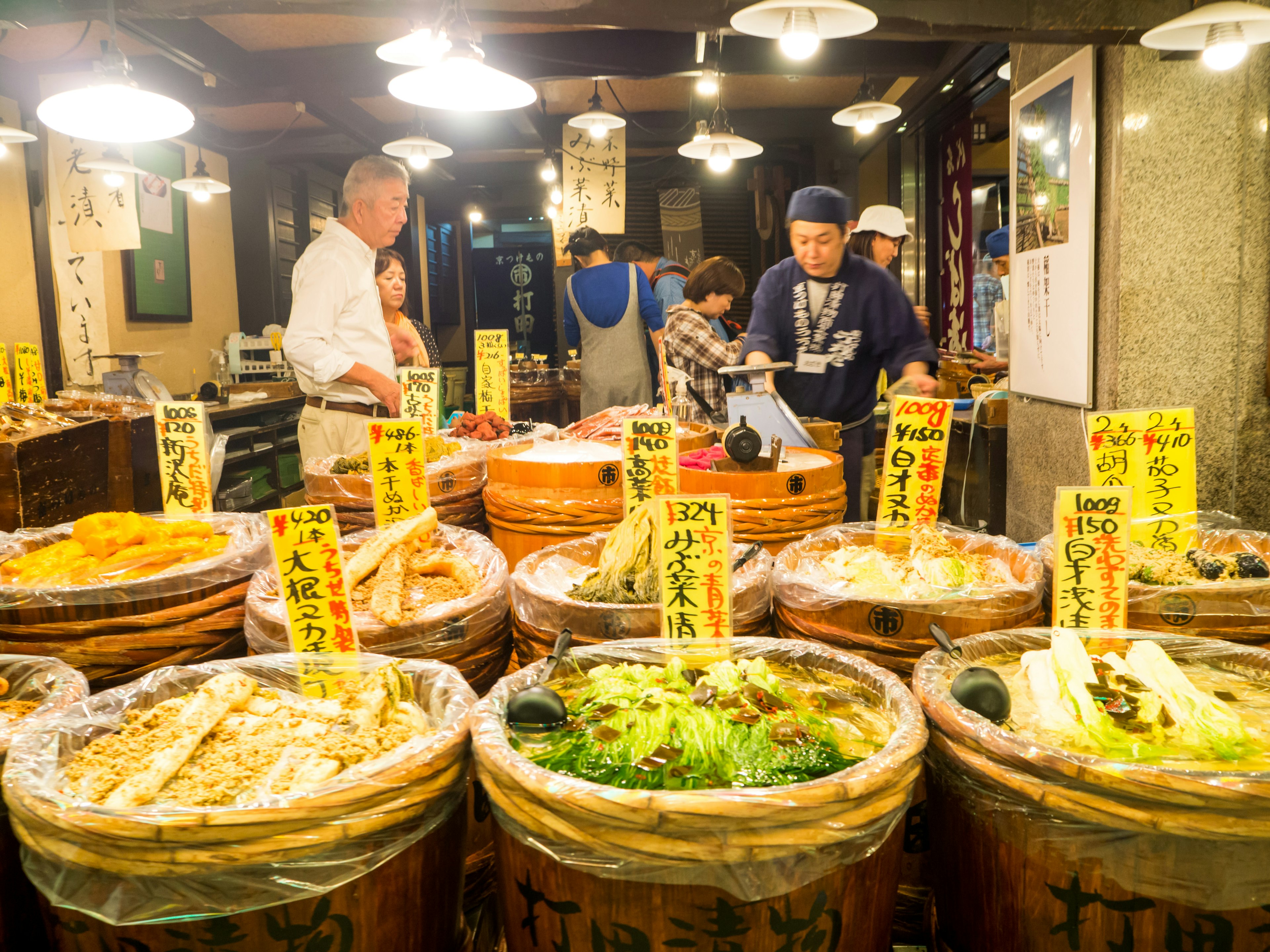 A traditionally dressed vendor selling food at the Nishiki Market in Kyoto’s Nakagyo neighborhood