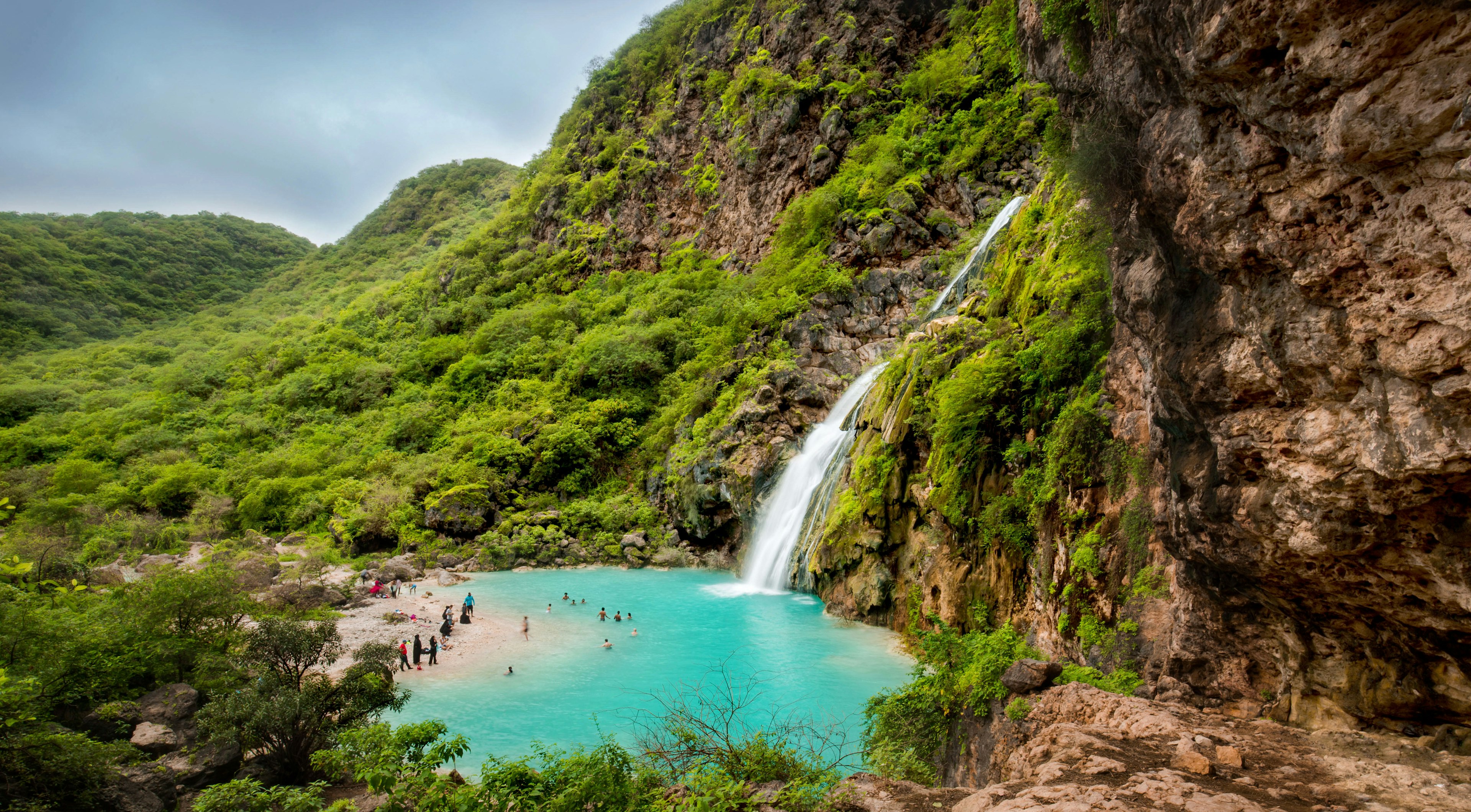 An aerial view of Ayn Khor waterfalls among greenery in Salalah, Oman