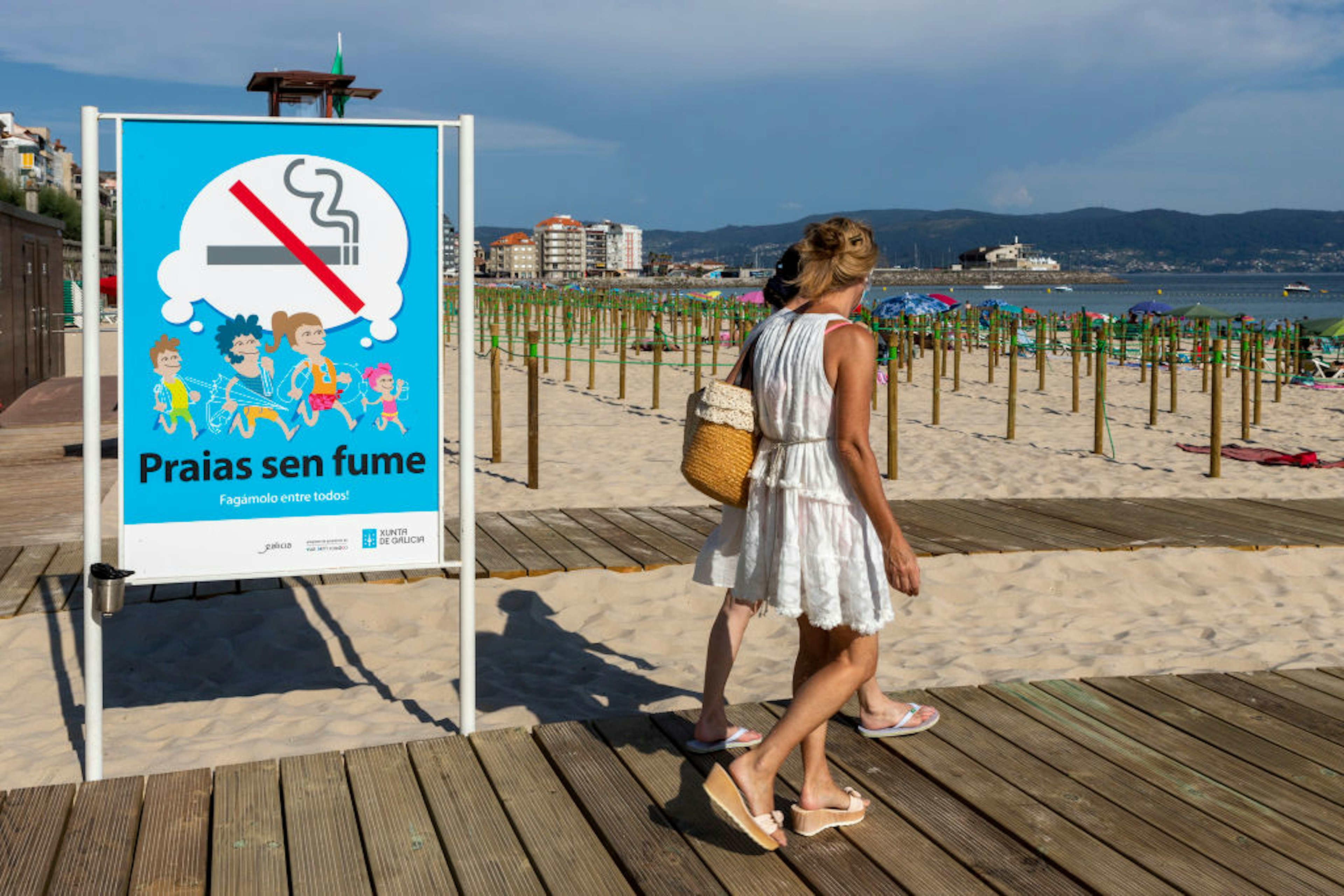 SANXENXO, SPAIN - JULY 11: A sign announces that smoking is prohibited on July 11, 2020 in Sanxenxo, Galicia, Spain. The municipality of Sanxenxo has adapted Silgar beach, in the Rías Baixas region, to protect bathers and tourists from the Covid-19 pandemic. (Photo by Xurxo Lobato/Getty Images)