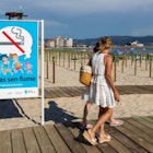 SANXENXO, SPAIN - JULY 11: A sign announces that smoking is prohibited on July 11, 2020 in Sanxenxo, Galicia, Spain. The municipality of Sanxenxo has adapted Silgar beach, in the Rías Baixas region, to protect bathers and tourists from the Covid-19 pandemic. (Photo by Xurxo Lobato/Getty Images)