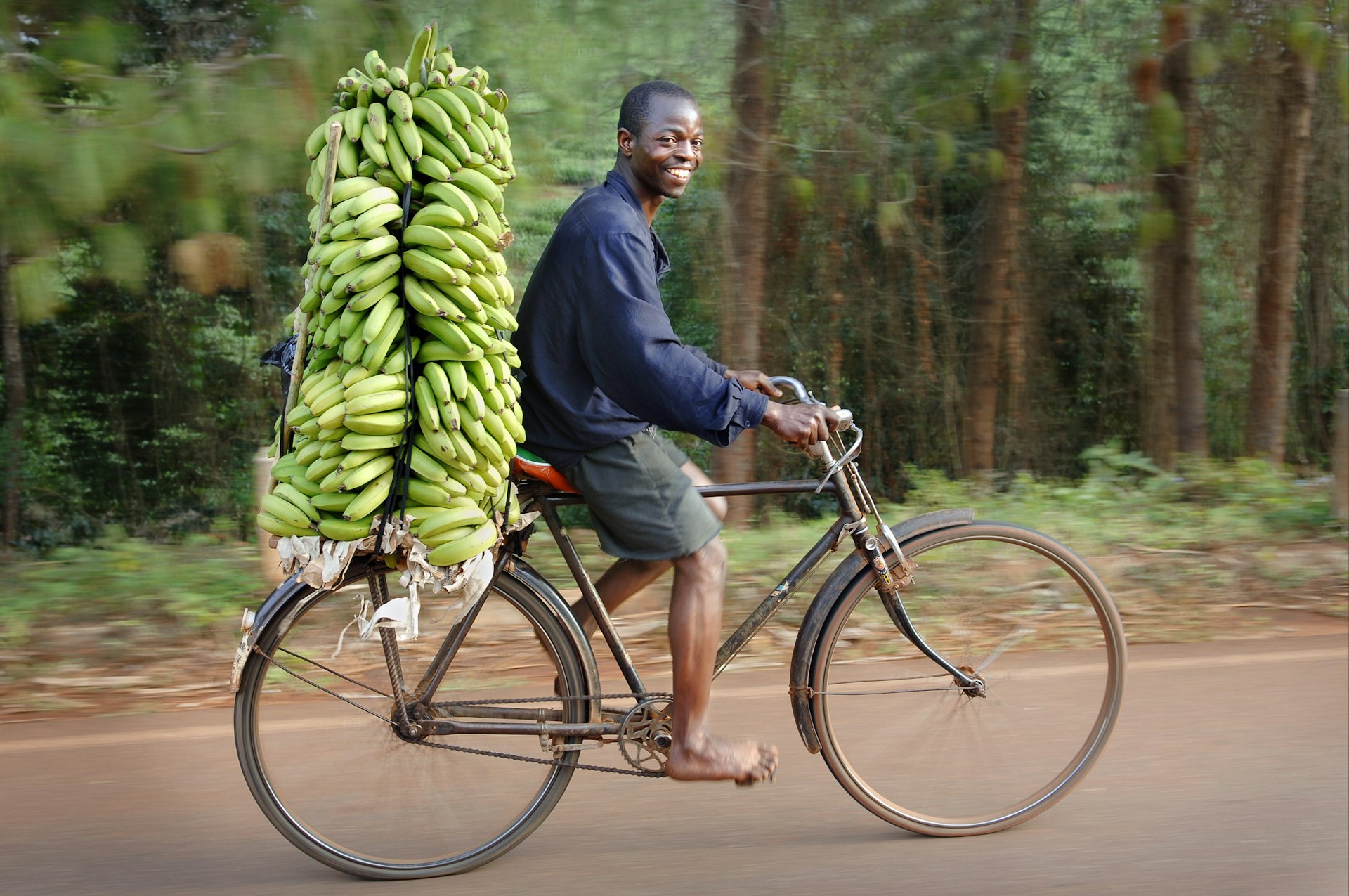 A man bicycling with bananas in Malawi