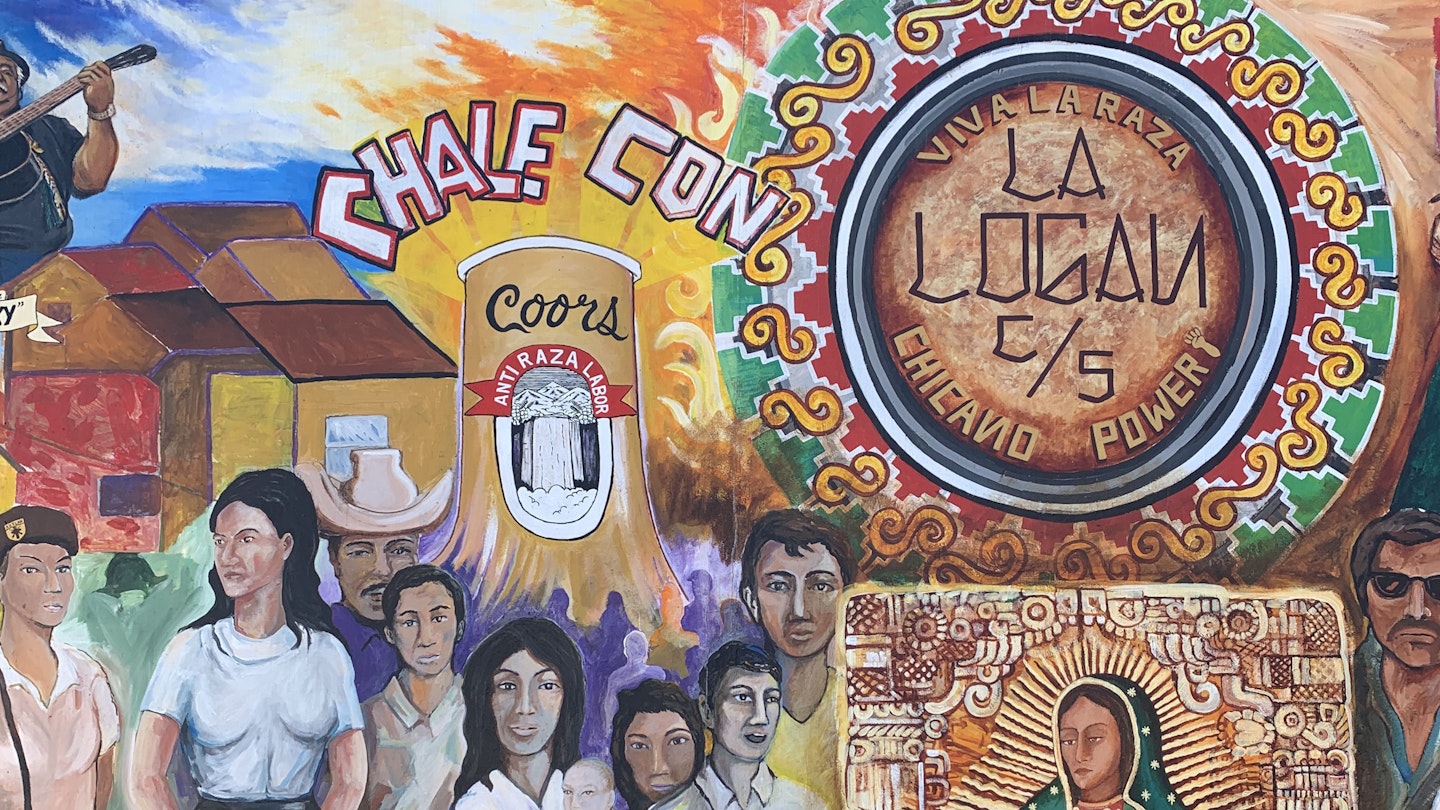 Closeup of a colorful mural on a wall in Barrio Logan in San Diego. The mural depicts influential people in the Latino community. 