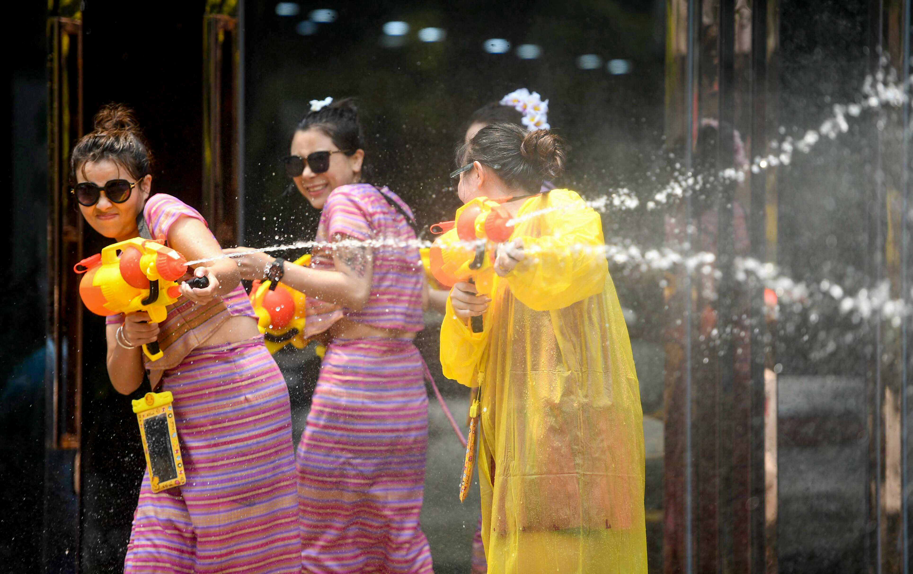 XISHUANGBANNA, April 15, 2019 -- People celebrate the water-sprinkling festival on a street in Jinghong City, Dai Autonomous Prefecture of Xishuangbanna, southwest China's Yunnan Province, April 15, 2019. People sprinkle water to each other to pray for good fortune during the traditional water-sprinkling festival, which is also the New Year festival of the Dai ethnic group. (Xinhua/qinqing via Getty Images)