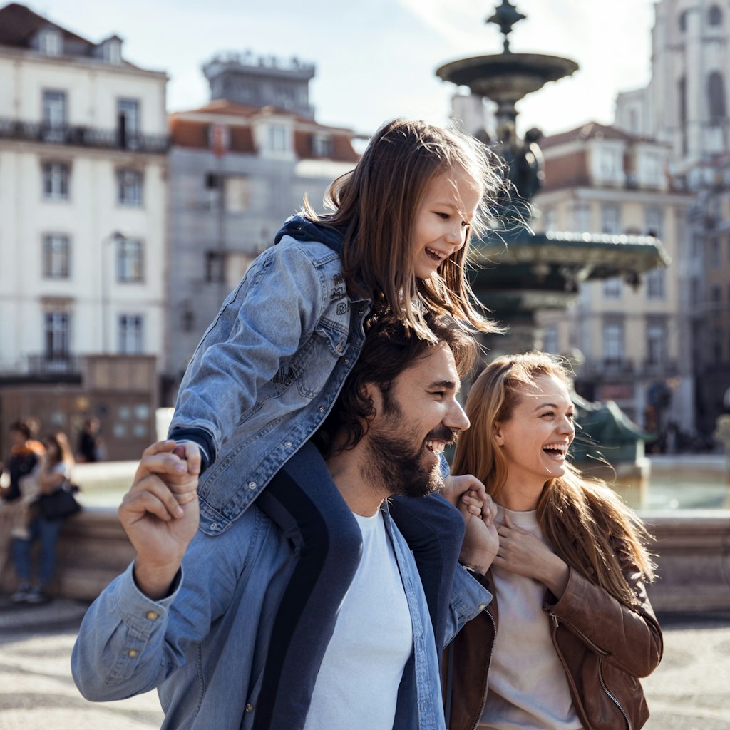 Close up of a young happy family exploring the Rossio Square