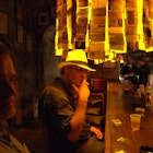 A man joins locals in the El Batey bar in San Juan, Puerto Rico