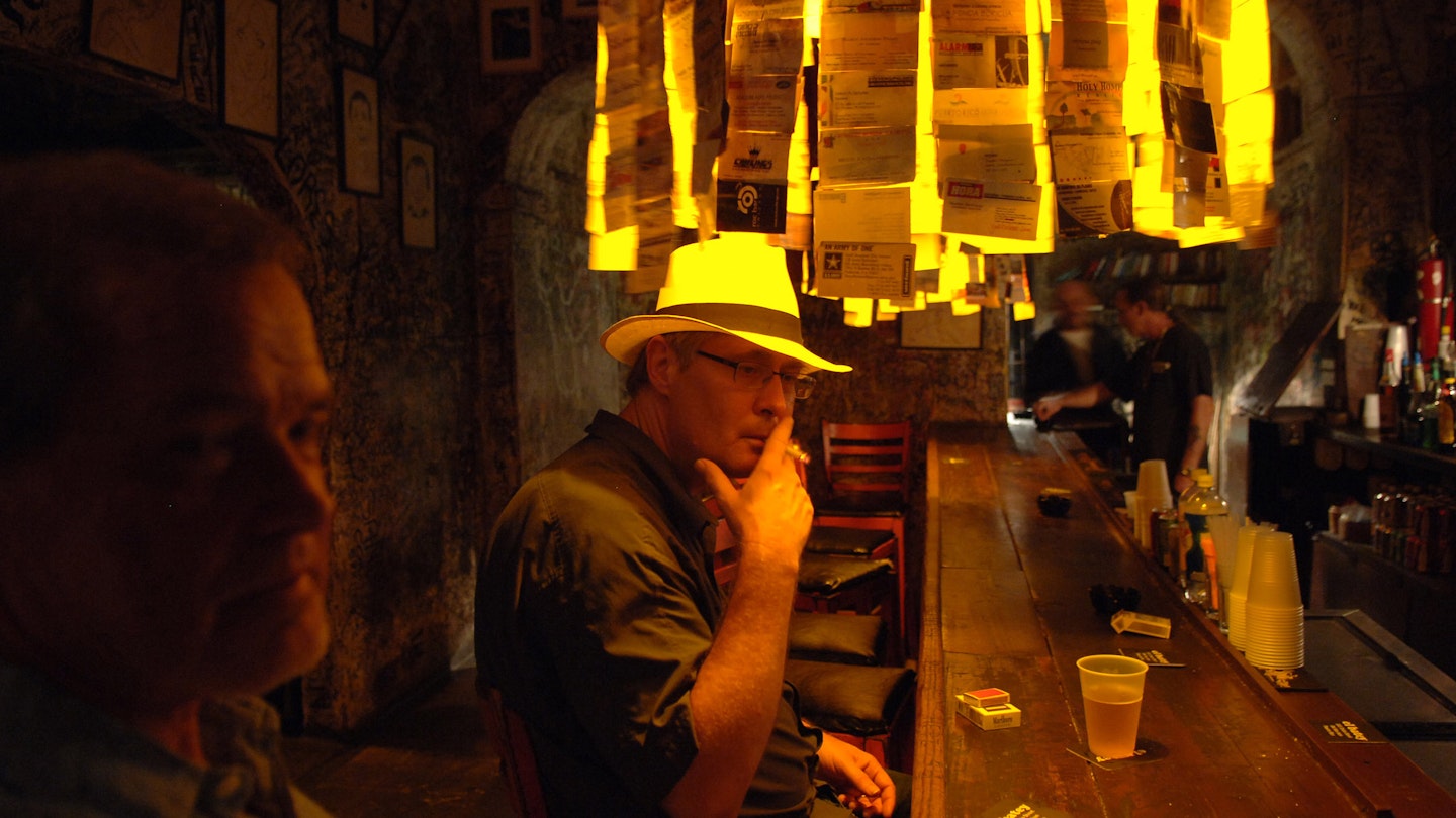 A man joins locals in the El Batey bar in San Juan, Puerto Rico