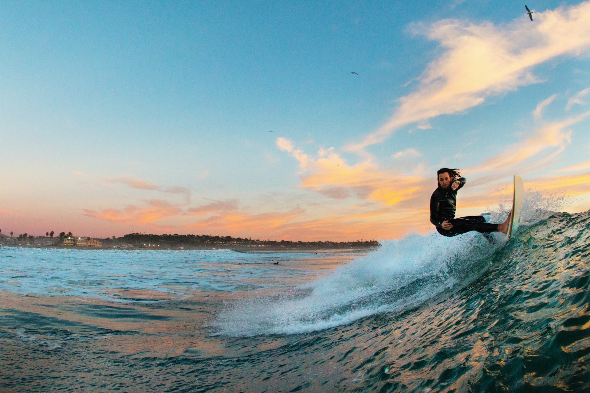 Young male surfer surfing a wave, Cardiff-by-the-Sea, California, USA