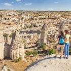 Two walkers looking at fairy chimneys in Cappadocia