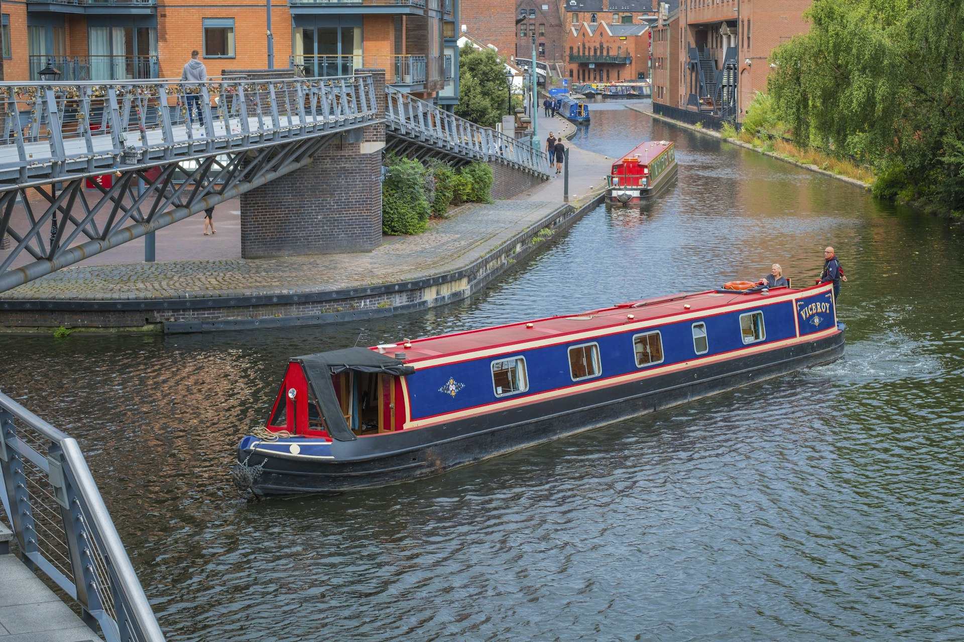 A narrowboat negotiates the corner on the Birmingham Canal Old Main Line at Salvage Turn Bridge by The Mailbox