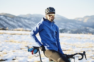 A cyclist pauses on a snowy track in Colorado