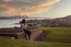 Girl admiring the view towards Auckland from North Head