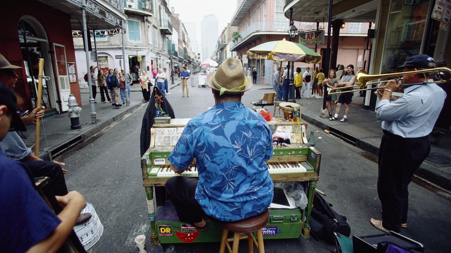 David Roe, a pianist, performs on his colorful piano along with fellow street musicians in Royal Street in New Orleans.