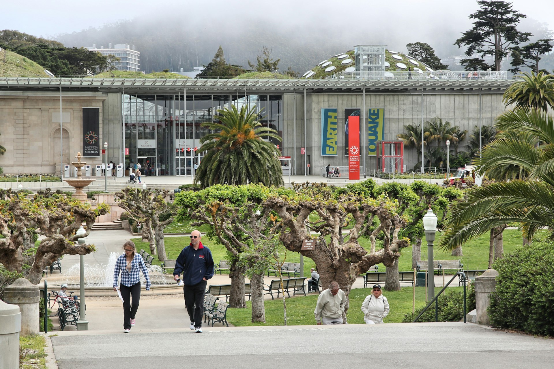 People walking by the California Academy of Sciences