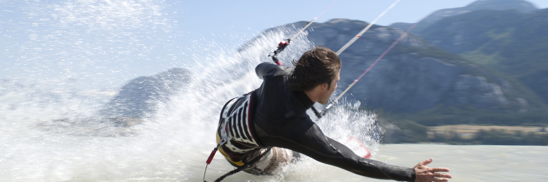 man kiteboarding, on water