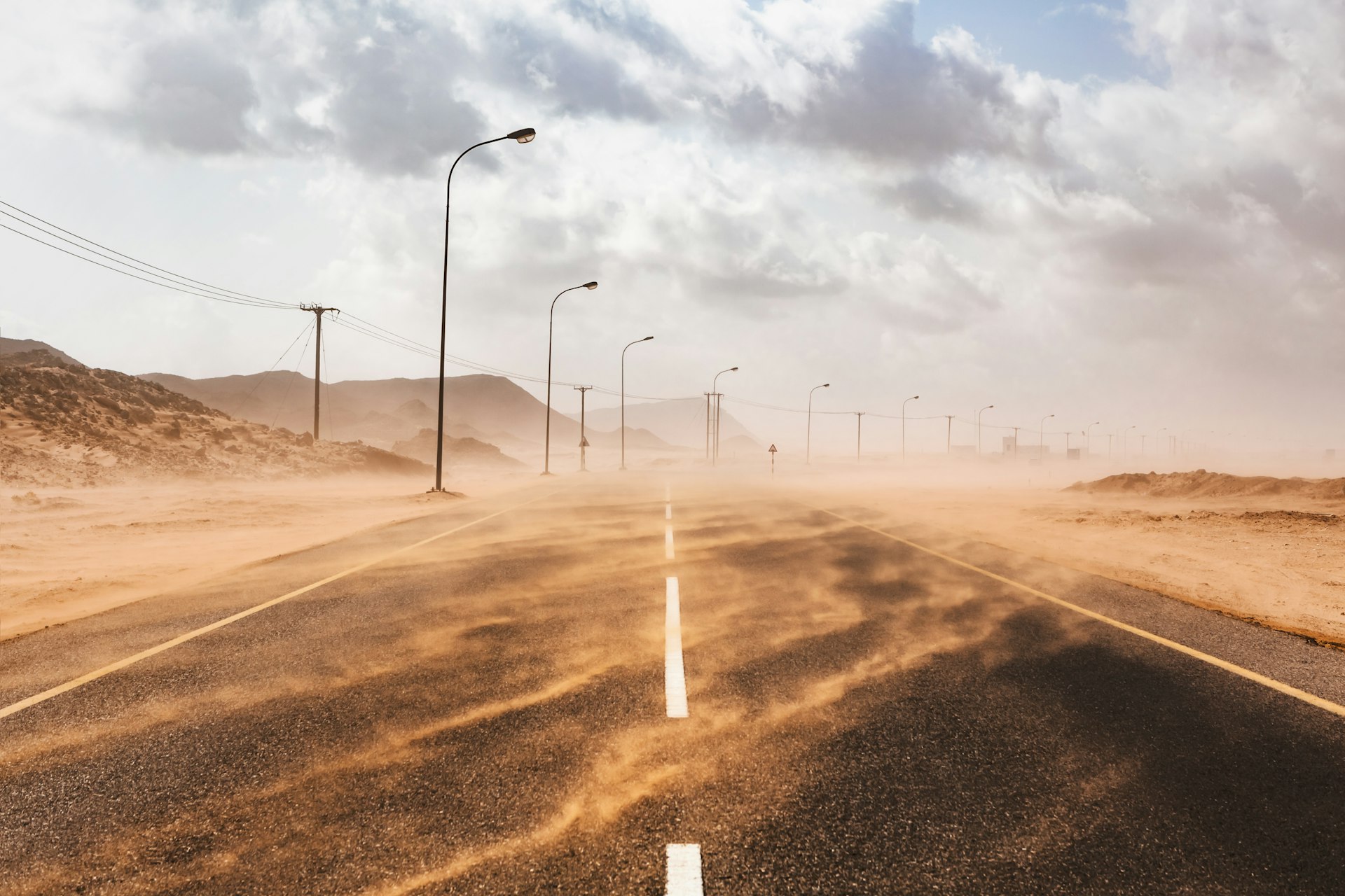 Sand blows across a road during a sandstorm in Ras al Hadd, Oman