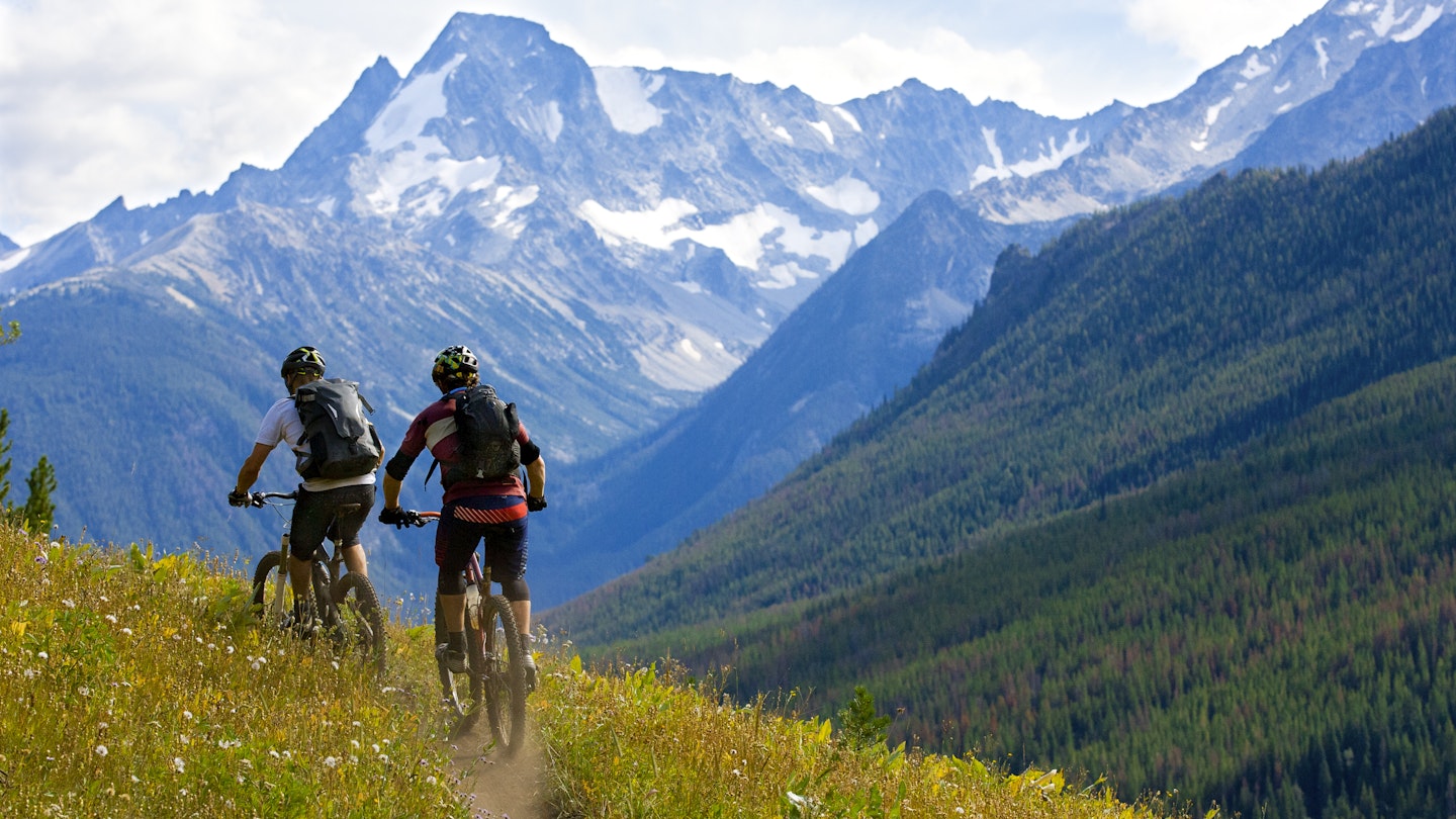 Two male mountain bike riders enjoy a cross country trail in British Columbia, Canada.
